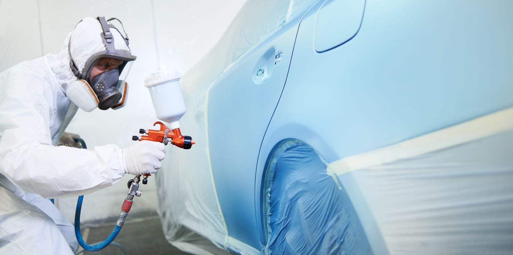 Technician Applying Paint to Car